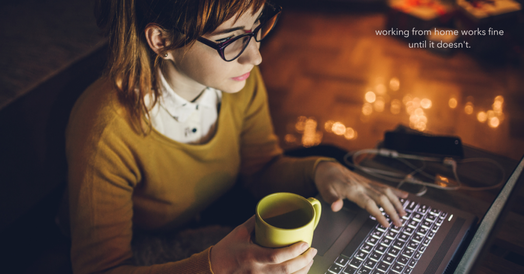 Woman working late at home on a laptop with a coffee mug, representing the challenges of remote work